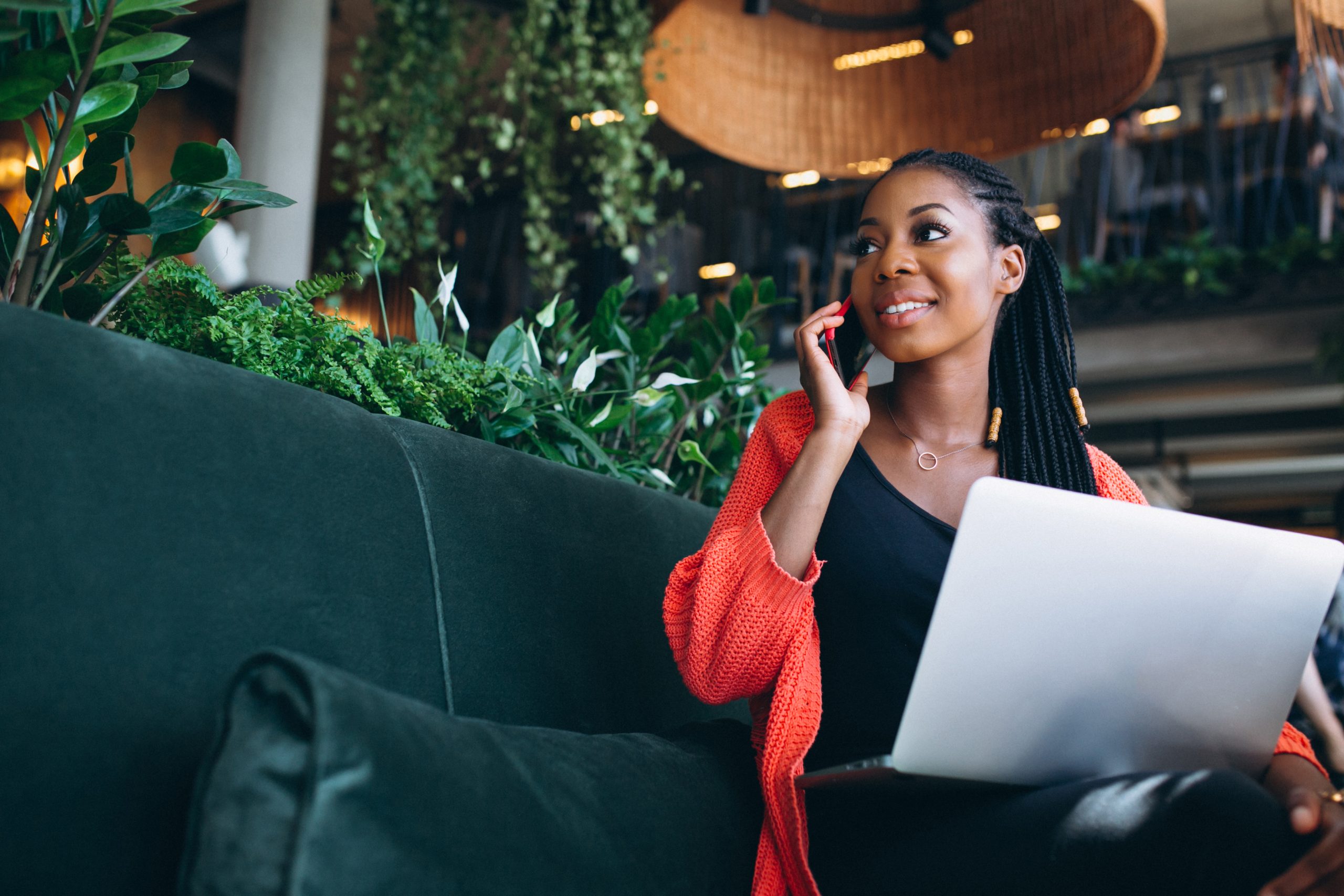 Femme travaillant dans un caf&eacute; avec t&eacute;l&eacute;phone et ordinateur